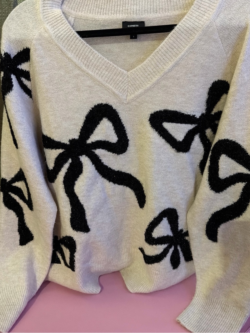 Express Cream V-Neck Sweater with Black Bow Motif